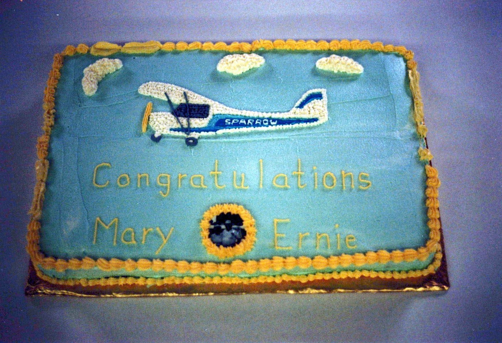 Celebration cake decorated with a Carlson Sparrow and inscribed Congratulations Mary and Ernie