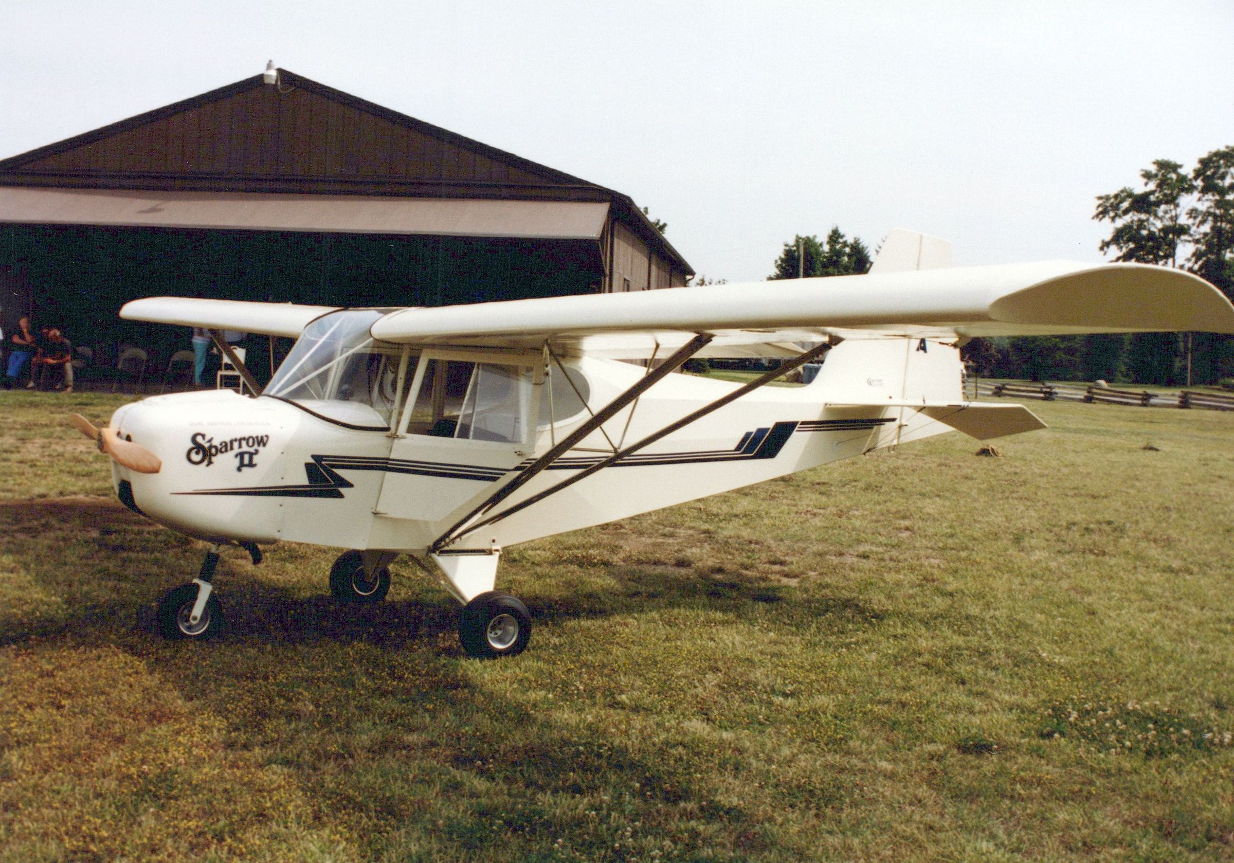 Carlson Sparrow II parked beside a hangar