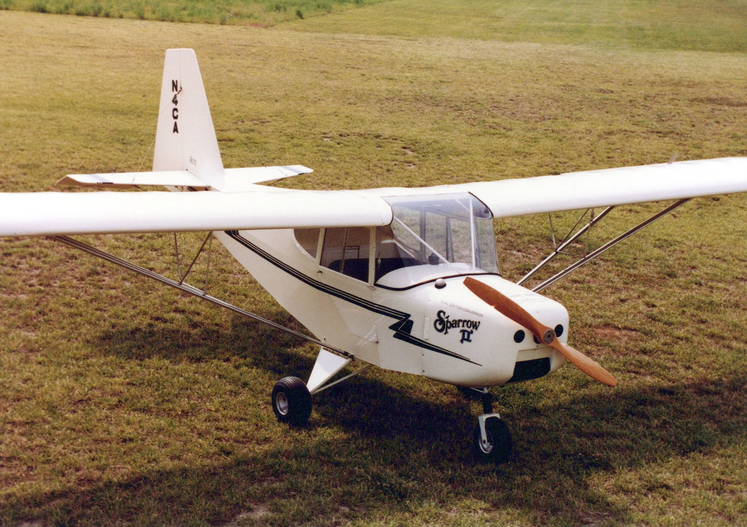 White Carlson Sparrow II with Sparrow II lettering on the cowling, parked on grass