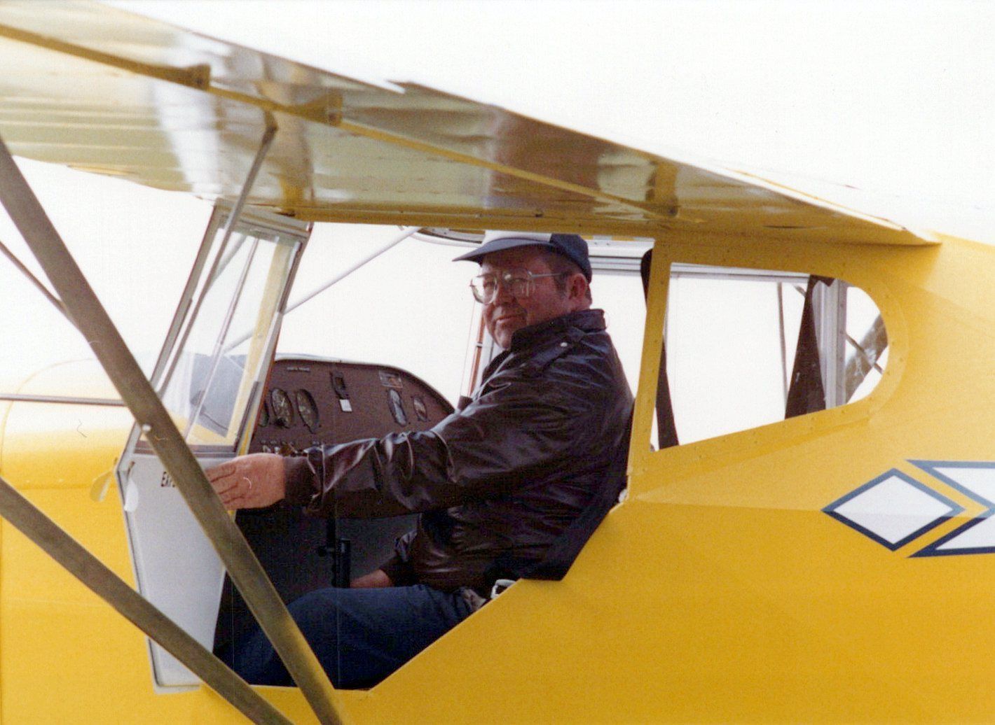 Pilot seated in the cabin of the yellow Carlson Sparrow II XTC demonstrator