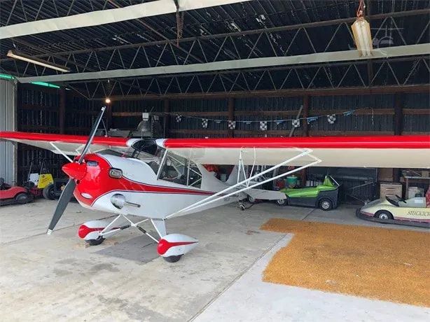 White and red Carlson Sparrow Sport Special inside a hangar