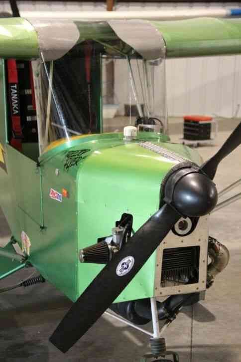 Nose, engine and two-blade propeller of a green Carlson Sparrow Ultralight